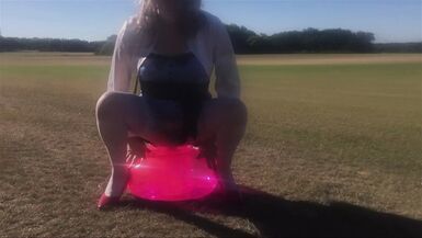 CD Slut Riding Dildo Seat Outdoors In A Field - 1 image