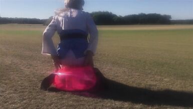 CD Slut Riding Dildo Seat Outdoors In A Field - 7 image
