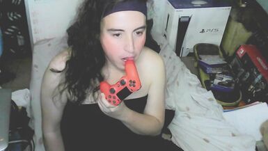 Cute cd girl, beautiful eyes and face. Kissing, licking and sucking a playstation controller. Sweet cd girl next door. - 3 image