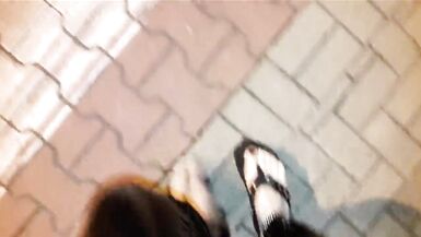 crossdresser on a public street in latex leggings and sexy platform flip flops - 2 image