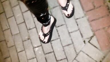 crossdresser on a public street in latex leggings and sexy platform flip flops - 5 image