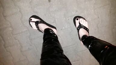 crossdresser on a public street in latex leggings and sexy platform flip flops - 6 image