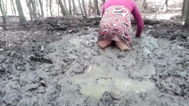 in a mini dress she is playing in the mud - 1 image