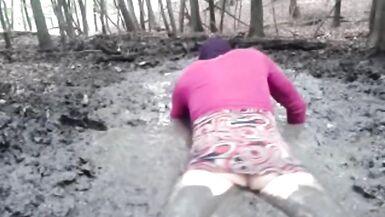 in a mini dress she is playing in the mud - 4 image