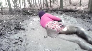 in a mini dress she is playing in the mud - 7 image