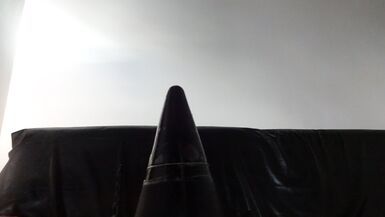 perv Latexnun is sitting on giant assplug - 1 image