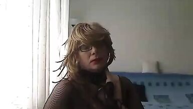 horny MILF tranny dressed only in black fishnet and heels talking in a sexy voice and showing off her sexy body - 1 image