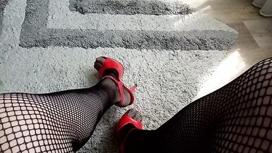 horny MILF tranny speaks in a sexy voice and shows her long legs in high heels and fishnet stockings and masturbates lightly - 1 image