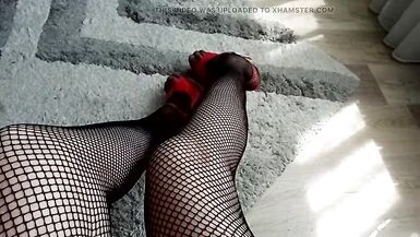 horny MILF tranny speaks in a sexy voice and shows her long legs in high heels and fishnet stockings and masturbates lightly