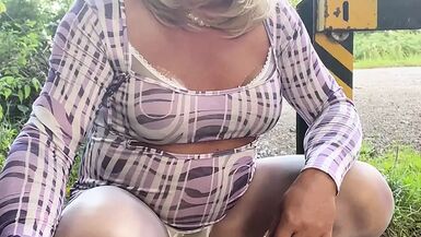 Amateur crossdresser Kellycd2022 sexy milf peeing and masturbating in sexy white panties and pantyhose out in the woods - 1 image