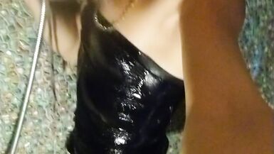 Wetlook transgirl in bathroom wearing in black dress, skirt, pantyhose and high heels