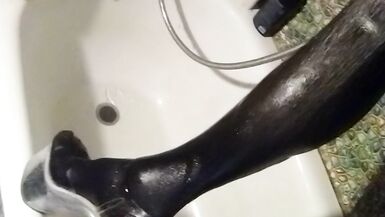 Wetlook transgirl in bathroom wearing in black dress, skirt, pantyhose and high heels - 14 image