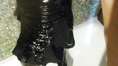 Wetlook transgirl in bathroom wearing in black dress, skirt, pantyhose and high heels - 9 image