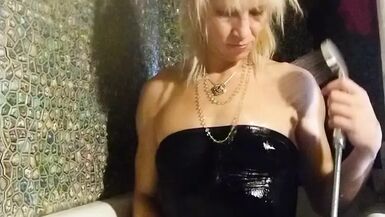 Trans girl masturbates in the bathroom wearing black pantyhose, miniskirt, dress and high heels - 1 image