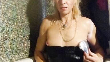 Trans girl masturbates in the bathroom wearing black pantyhose, miniskirt, dress and high heels