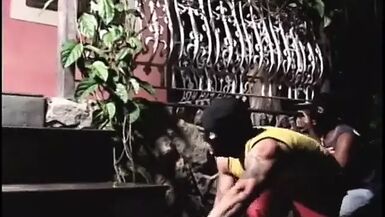 Tranny is sucking his cock before they fuck in bed - 1 image