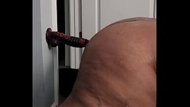 Chubby tranny plows dildo on wall - 1 image