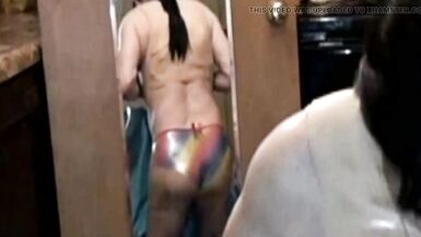 Transexual with big fake boobs titfucks and gives blowjob to huge dildo while wearing metallic panties. - 8 image