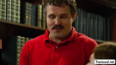 Watch this hot shemale dominate her butthole in the library with his massive cock - 1 image