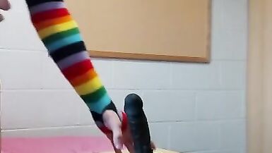 Rainbow Femboy in a Chastity Cage and Shiny Leotard Rides a BBC Dildo - 1 image